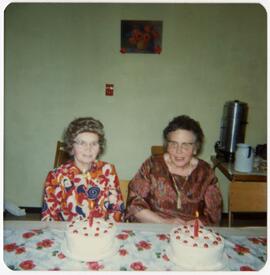 Norah Doherty and companion with birthday cakes