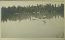 Man Paddling Canoe on River