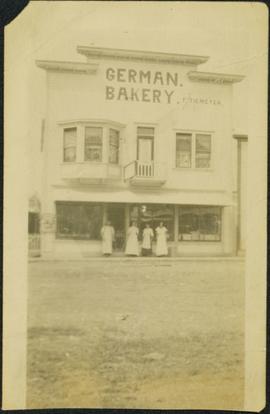 Man & Women Standing at German Bakery