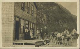 Group of People and Horse and wagon in front of building