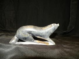 Carving of arctic mammal with brass plate inscribed "Canada Cup 1976"