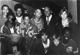 Members of the Harlem Globetrotters basketball team and school children