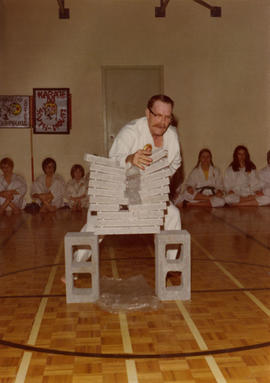 J. Harry Crawshaw breaking cement blocks with karate chop
