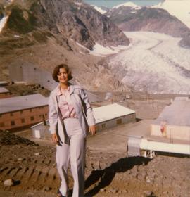 Iona Campagnolo standing in front of Granduc mining operation and glacier
