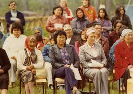 Iona Campagnolo sitting with First Nations people at an event