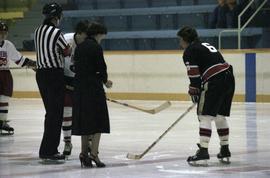 Iona Campagnolo holds hockey puck for face off for game in Kitimat arena