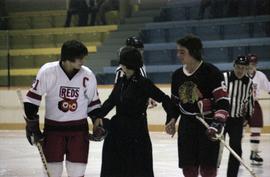 Hockey players supporting Iona Campagnolo on the ice in Kitimat arena