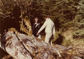 Iona Campagnolo looking at a fallen totem pole with Peter Jones