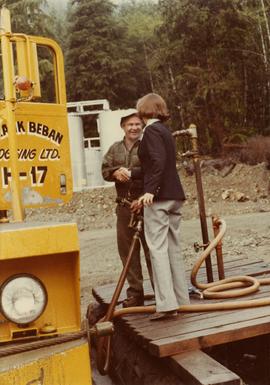 Iona Campagnolo shaking hands with unidentified employee of Frank Beban Logging