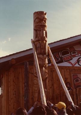 Kispiox community members helping to raise a totem pole