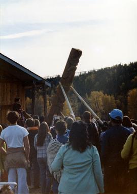Kispiox community members watching a totem pole being raised