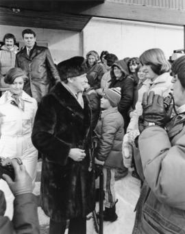 Iona Campagnolo and Pierre Trudeau talk with a crowd at a children's speed skating event