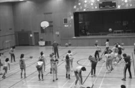 Mount Elizabeth Secondary School students toss basketballs in a physical education class