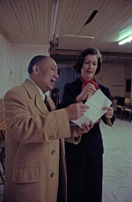 Iona Campagnolo examines a document with Earl Mah in the Prince Rupert Chinese Senior Centre