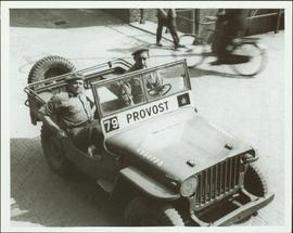 Two members of the No. 1 Canadian Provost Corps in a jeep