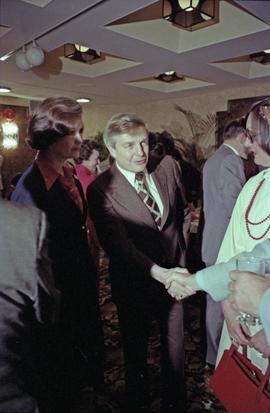 Iona Campagnolo and Premier Peter Lougheed greet unidentified people at the Crest Hotel in Prince Rupert