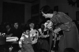 Iona Campagnolo hands flowers to Chinese-Canadian children at Chinese New Year event