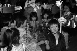 Chinese-Canadian Children hold flowers at a Chinese New Year event in Prince Rupert