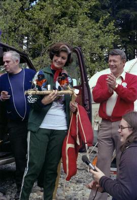 Iona Campagnolo holds handmade rafting figurines at Kitimat Delta King Days raft event with Mayor George Thom