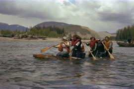 Iona Campagnolo and unidentified men paddling raft on Kitimat River during Delta King Days event