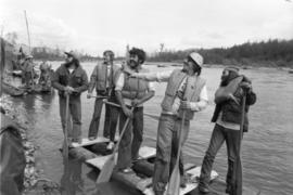 Iona Campagnolo and unidentified men stand on raft during Kitimat Delta King raft race