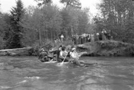 Iona Campagnolo paddles raft with unidentified men during Kitimat Delta King Days raft race