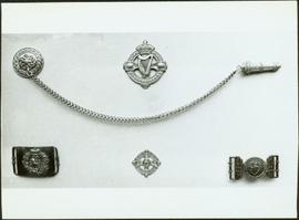 Closeup of Royal Irish Constabulary badges, buckles and whistle chain
