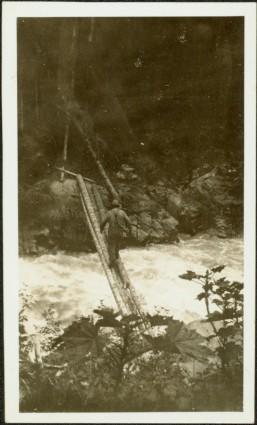 Man Crossing Log Pole Bridge at Canyon Creek, BC