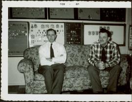 James Joseph Claxton seated on a couch beside an unidentified man