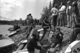 Iona Campagnolo and others sitting on rafts on shore during the Kitimat Delta King Days raft race