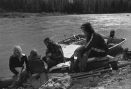 Iona Campagnolo sitting on beached raft with man and children during the Kitimat Delta King Days raft race