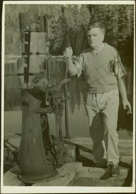 Man holding the lever of a piece of wharf machinery