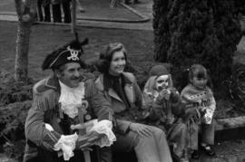 Iona Campagnolo, man in pirate costume, and children sitting on the curb at the Prince Rupert Sea Festival
