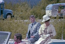 Mayor George Thom and woman riding on convertible in the Kitimat Captain Cook Bicentenary parade