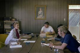 Iona Campagnolo and men in meeting room at fish cannery
