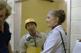 Iona Campagnolo standing with a male worker while on tour of a fish cannery