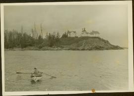 Woman wearing Cowichan sweater rowing a boat away from a lighthouse