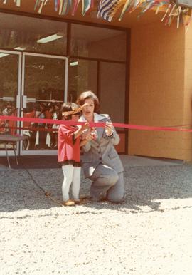 Iona Campagnolo with child cutting ribbon at opening of Haisla Recreation Centre in Kitamaat Village