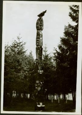 Totem pole standing amongst the trees