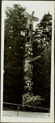 Fenced totem pole amongst the trees