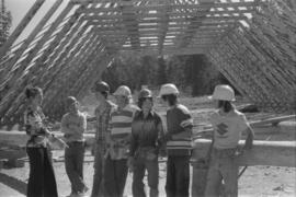 Iona Campagnolo, men, and teenagers at a construction site, possibly for a Young Canada Works project