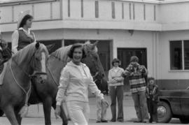 Iona Campagnolo walking in parade in Smithers in front of horses