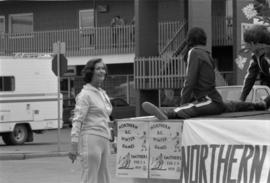 Iona Campagnolo next to parade float for the 1979 Northern BC Winter Games in Smithers