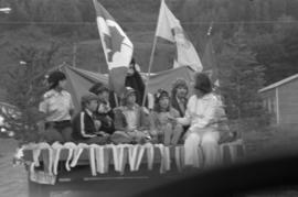 Iona Campagnolo and children riding on a truck bed in a parade in Smithers