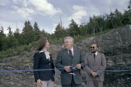 Iona Campagnolo, man, and Joe Scott with scissors cutting ribbon at opening ceremony for Scott Road Highway opening in Prince Rupert