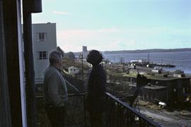 Iona Campagnolo and Joe Scott on balcony with view of Prince Rupert and ocean