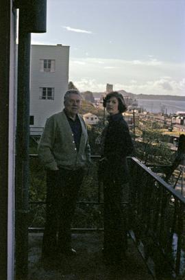 Iona Campagnolo and Joe Scott on balcony with view of Prince Rupert and ocean