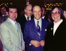 Prime Minister Pierre Trudeau, Evelyn Basso and man with crowd at Northern BC Winter Games event in Prince George