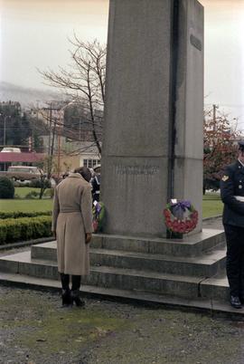 Iona Campagnolo with bowed head at cenotaph monument at Remembrance Day ceremony