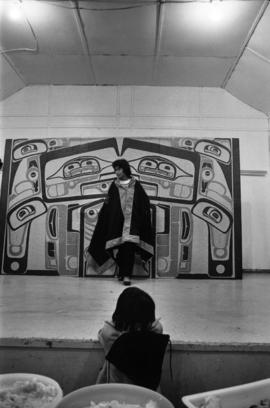 Glen Vowell First Nations child watching performance on stage at potluck